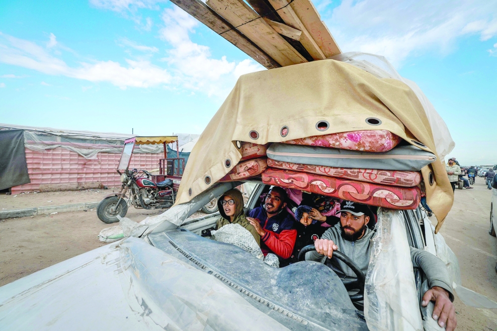 Palestinians fleeing Khan Yunis arrive in Rafah with their belongings in a damaged car. — AFP
