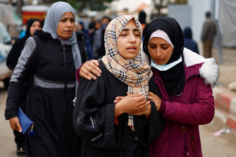 Mourners react near the bodies of Palestinians killed in Israeli strikes, at the European hospital in Khan Younis in the southern Gaza Strip