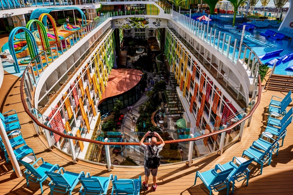A passenger snaps a photo of the Central Park promenade on board Royal Caribbeans Icon of the Seas, now the worlds largest cruise ship, before it departed port in Miami on Saturday, Jan. 27, 2024. (Scott McIntyre/The New York Times)