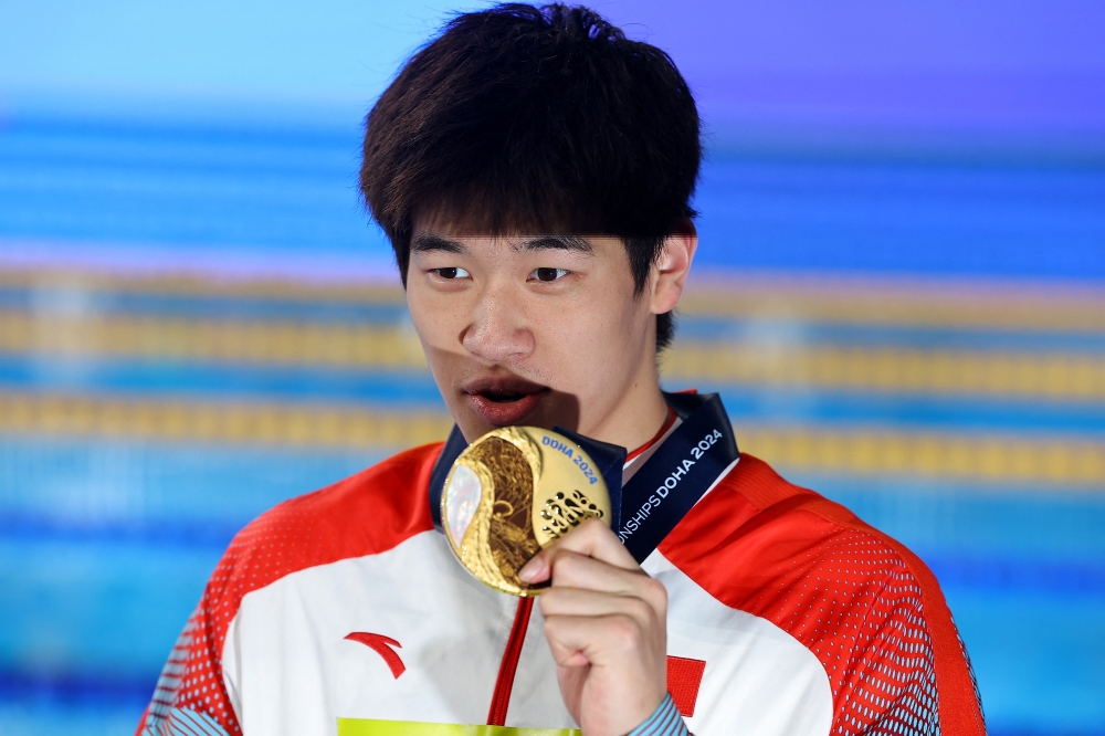 World Aquatics Championships - Aspire Dome, Doha, Qatar - February 15, 2024 Gold medallist China's Zhanle Pan celebrates with his medal after winning the men's 100m freestyle final 