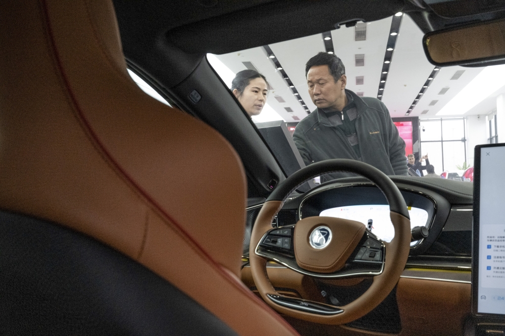 A saleswoman and customer at a BYD auto dealership in Shenzhen. 