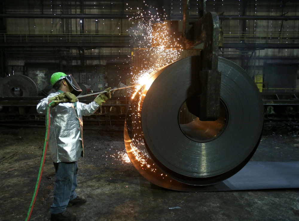 A worker cuts a piece from a steel coil at the Novolipetsk Steel PAO steel mill in Farrell, Pennsylvania. — Reuters
