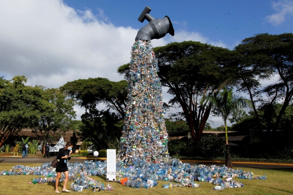 A delegate looks at a an installation called 'Turn Off the Plastic Tap', made with plastic waste collected from the Kibera slum in Nairobi and exhibited outside the United Nations Environment Programme Headquarters in Nairobi. — Reuters