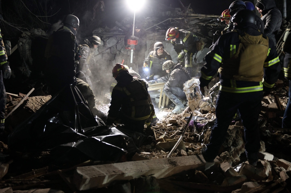 Ukrainian police officers and rescue workers clear the rubble of a destroyed private house after a Russian rocket attack in Kramatorsk, Donetsk region. — AFP 