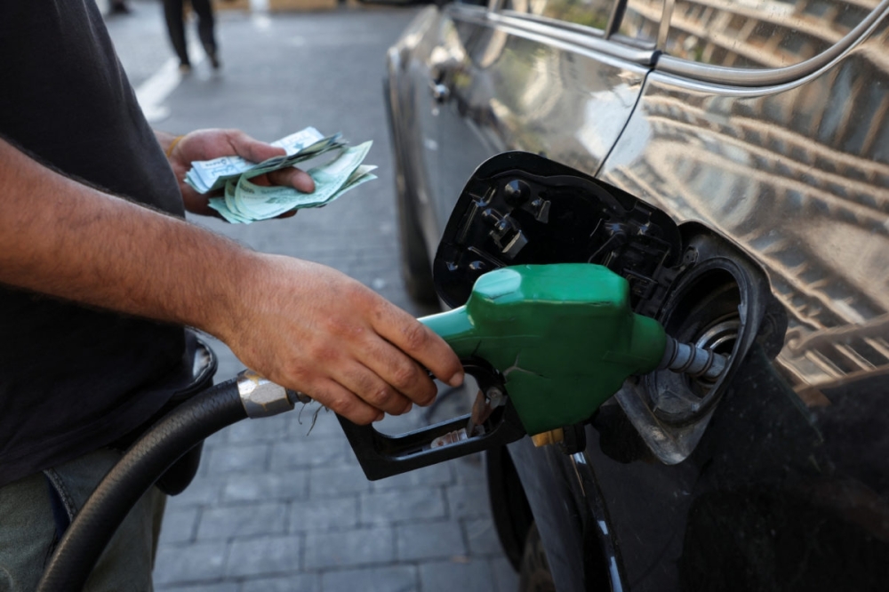 A worker fills up a car with fuel at a gas station, in this illustration photo. — Reuters