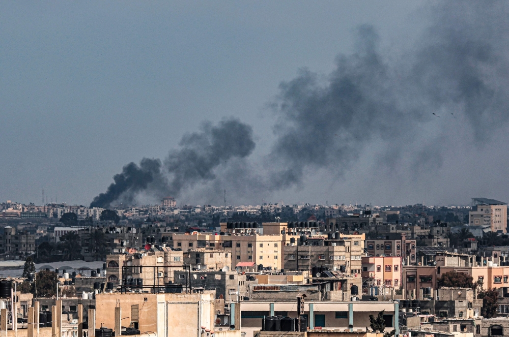 This picture taken from Rafah shows smoke billowing over Khan Yunis in the southern Gaza Strip during Israeli bombardment on February 20
