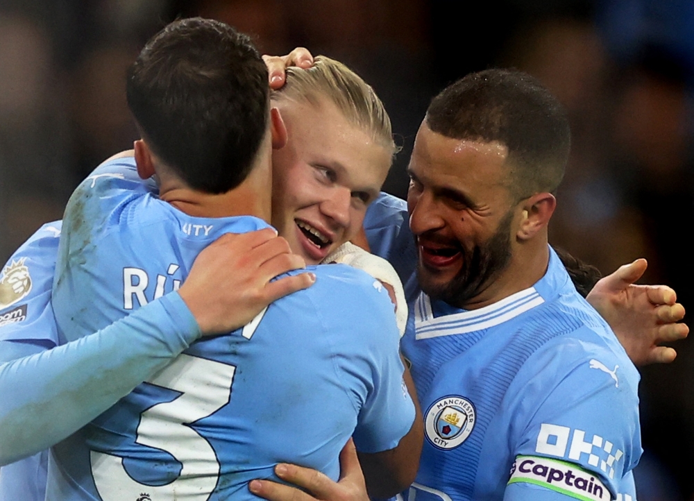 Soccer Football - Premier League - Manchester City v Brentford - Etihad Stadium, Manchester, Britain - February 20, 2024 Manchester City's Erling Braut Haaland celebrates scoring their first goal with Ruben Dias and Kyle Walker Action Images via Reuters/Lee Smith NO USE WITH UNAUTHORIZED AUDIO, VIDEO, DATA, FIXTURE LISTS, CLUB/LEAGUE LOGOS OR 'LIVE' SERVICES. ONLINE IN-MATCH USE LIMITED TO 45 IMAGES, NO VIDEO EMULATION. NO USE IN BETTING, GAMES OR SINGLE CLUB/LEAGUE/PLAYER PUBLICATIONS.
