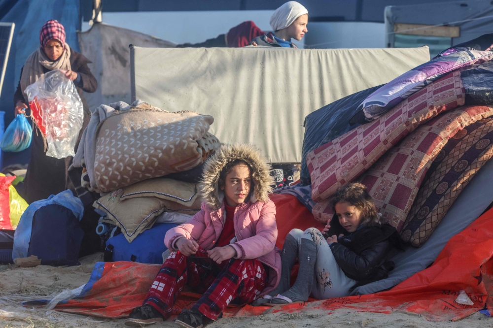 Displaced Palestinians check their belongings in a territory named Al-Mawasi after Israeli tanks reportedly raided the sector, Khan Yunis. 1 AFP 
