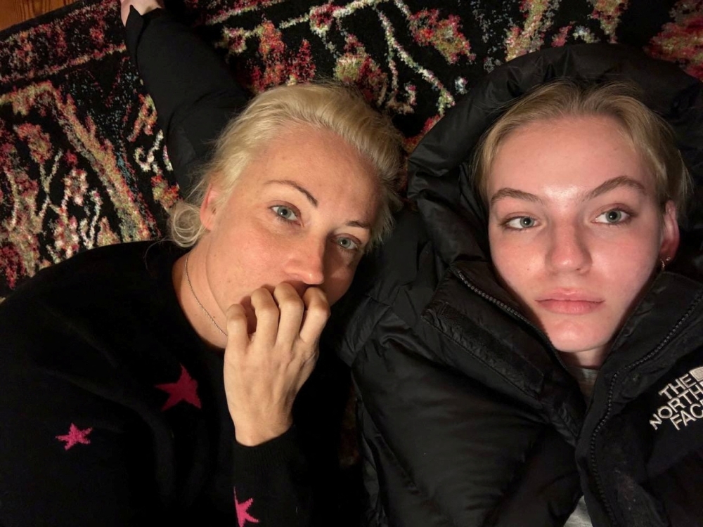 Yulia Navalnaya, the widow of Alexei Navalny, lies down with her daughter Dasha Navalnaya in an unknown location