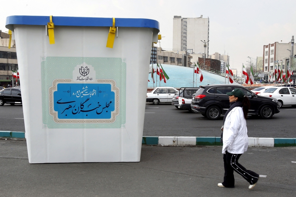 A woman walks past an installation of a ballot box during the first day of election campaign in Tehran 