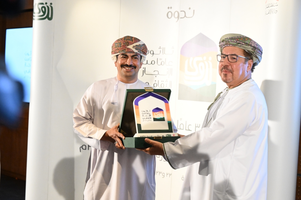 Dr Abdullah bin Nasser Al Harrasi, Minister of Information, with Saif bin Nasser al Rahbi, editor-in-chief of Nizwa magazine at MIBF in Muscat on Thursday. Photo by Hussein al Muqbali