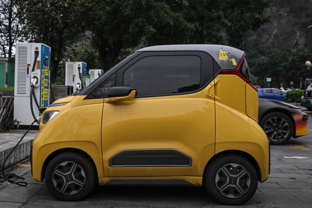  A decorated mini electric vehicle charging in Liuzhou, in southern China's Guangxi province