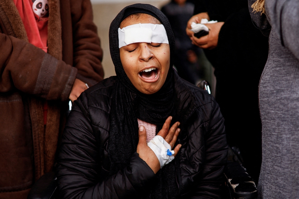 A Palestinian woman injured in an Israeli strike mourns the death of her sibling in the strike at Abu Yousef Al Najjar hospital in Rafah in the southern Gaza Strip. - Reuters
