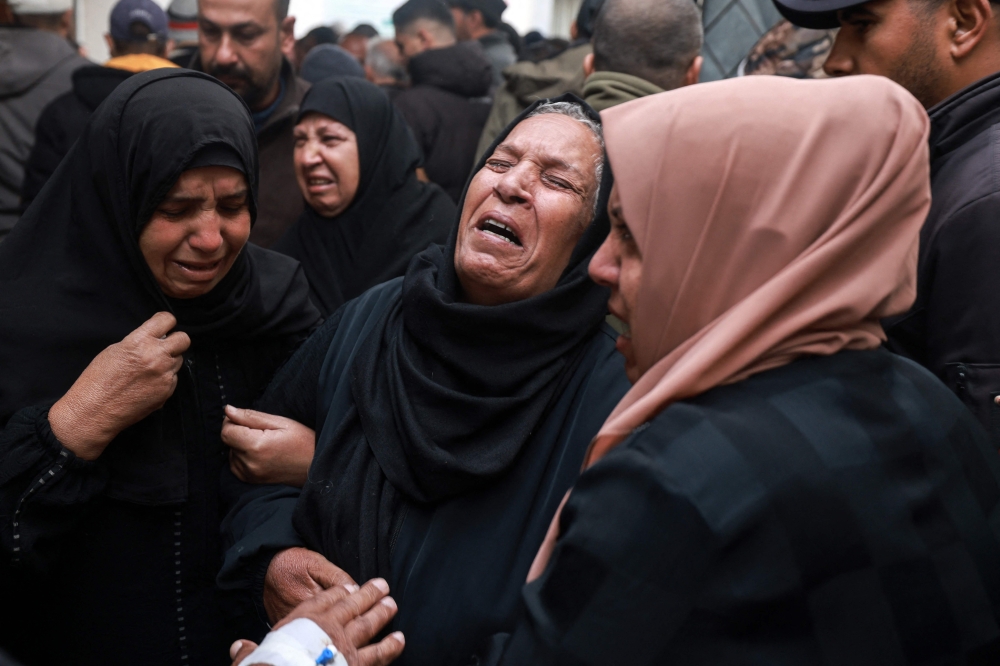 People mourn relatives killed in overnight Israeli bombardment outside the Al Najjar hospital in Rafah in the southern Gaza Strip. - AFP

