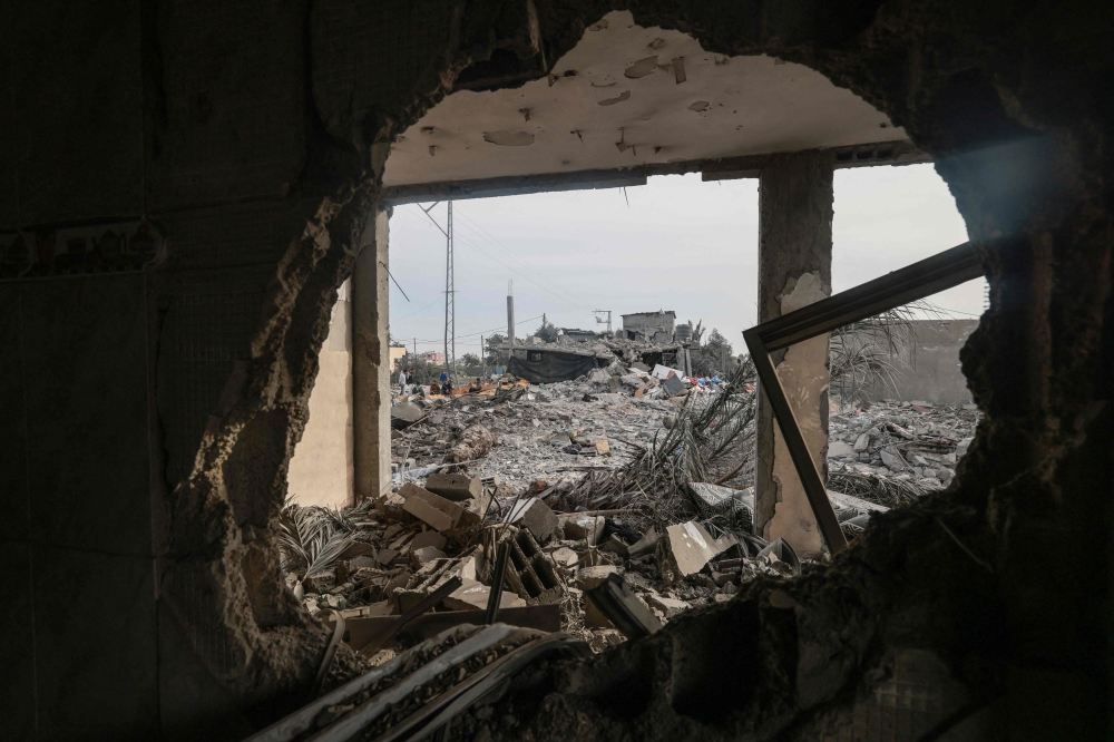People check the destruction caused by overnight Israeli bombardment in Rafah in the southern Gaza Strip on Friday. — AFP