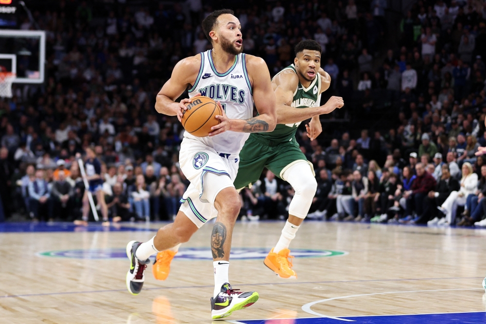 Feb 23, 2024; Minneapolis, Minnesota, USA; Minnesota Timberwolves forward Kyle Anderson (1) works towards the basket as Milwaukee Bucks forward Giannis Antetokounmpo (34) defends during the second half at Target Center. Mandatory Credit: Matt Krohn-USA TODAY Sports
