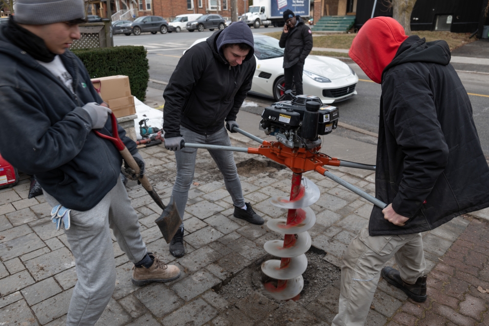 A dig to install bollards in the driveway at the home of Brad Lucas, in Toronto, Feb. 22, 2024. (Ian Willms for The New York Times)