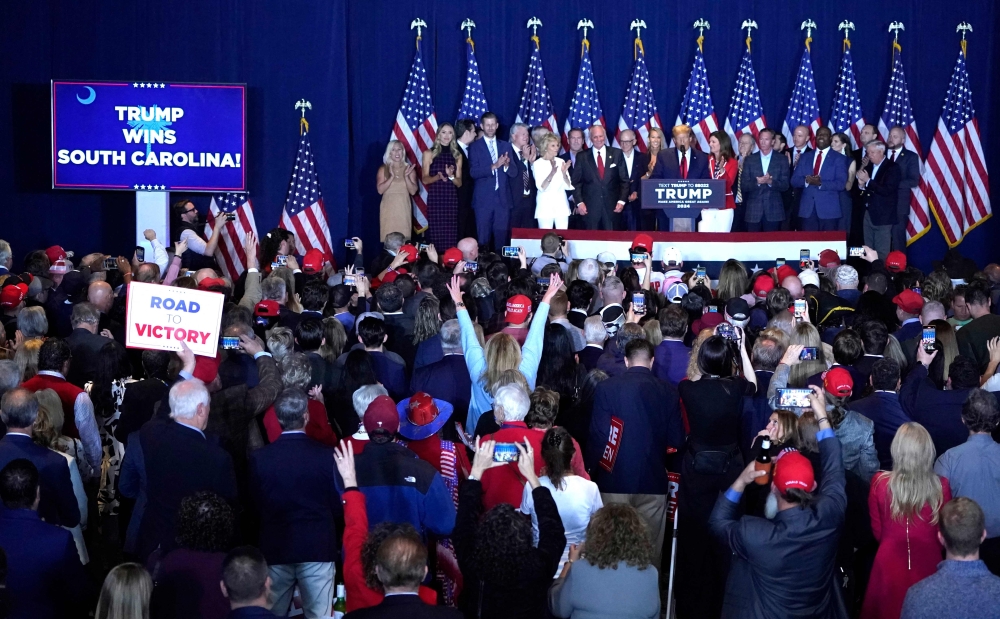 Former US Presidential hopeful and 2024 presidential hopeful Donald Trump (C) speaks at an "Election Night Watch Party" in Columbia, South Carolina, on February 24, 2024. Donald Trump won the Republican primary in South Carolina on Saturday, US media projections showed, defeating rival Nikki Haley and continuing his march toward the nomination ahead of November's presidential election.