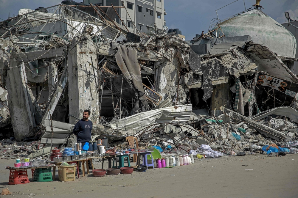 A vendor waits for customers along a street in Gaza City. — AFP 