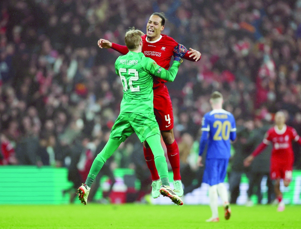 Liverpool's Virgil van Dijk and Caoimhin Kelleher celebrate after winning the Carabao Cup final on Sunday. — AFP