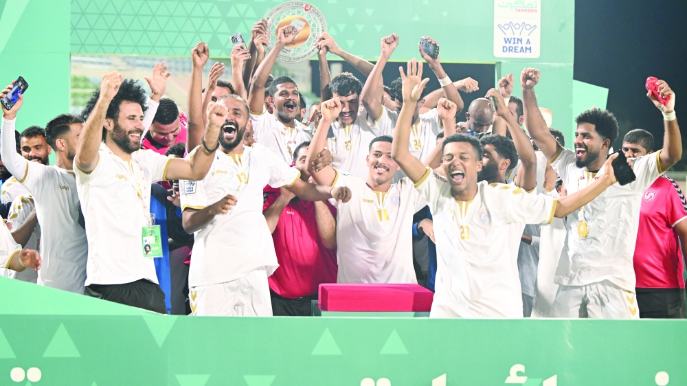Saham Club players celebrating league shield 