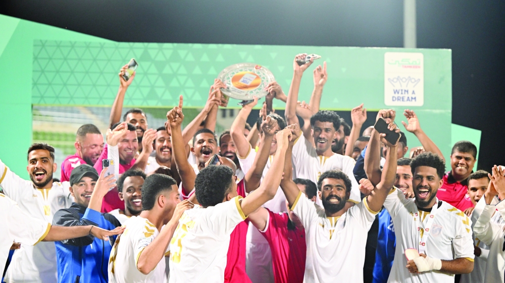 Saham Club players celebrating league shield 