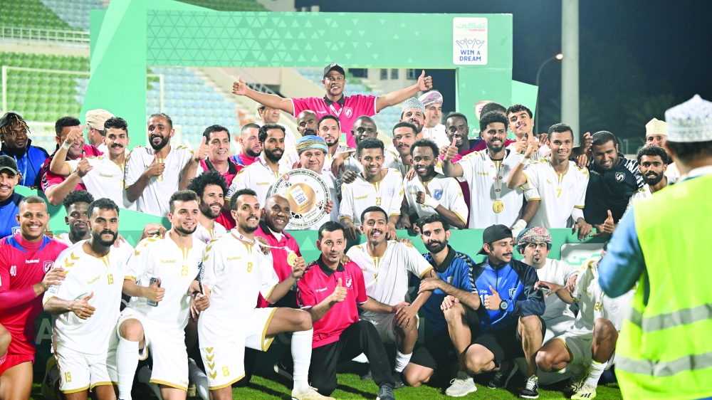 Saham Club players celebrating league shield 