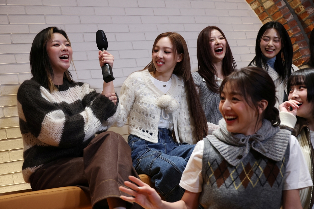 Members of the K-pop girl group TWICE laugh during an interview with Reuters in Seoul, South Korea, January 29, 2024.   REUTERS/Kim Hong-Ji
