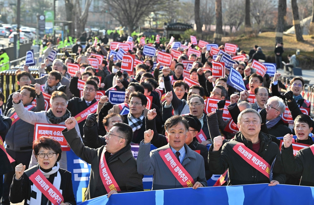 Doctors shout slogans during a rally to protest against the plan to raise the annual enrolment quota at medical schools, near the Presidential Office in Seoul. — AFP file photo 