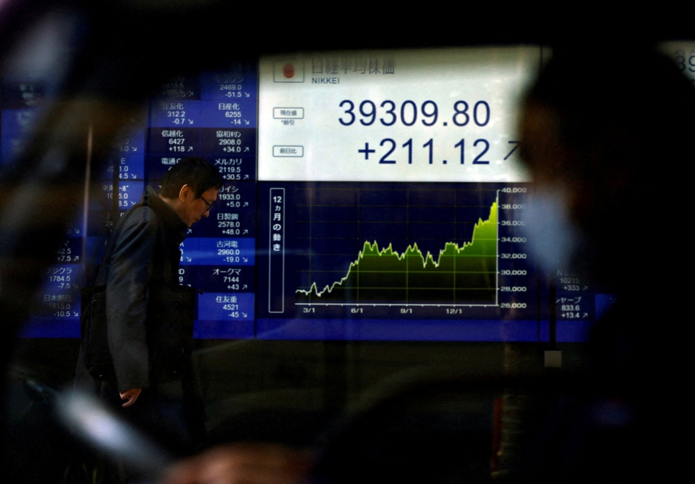 A digital screen shows Japan's Nikkei share average and stock prices reaching a historic peak in Tokyo, Japan. — Reuters