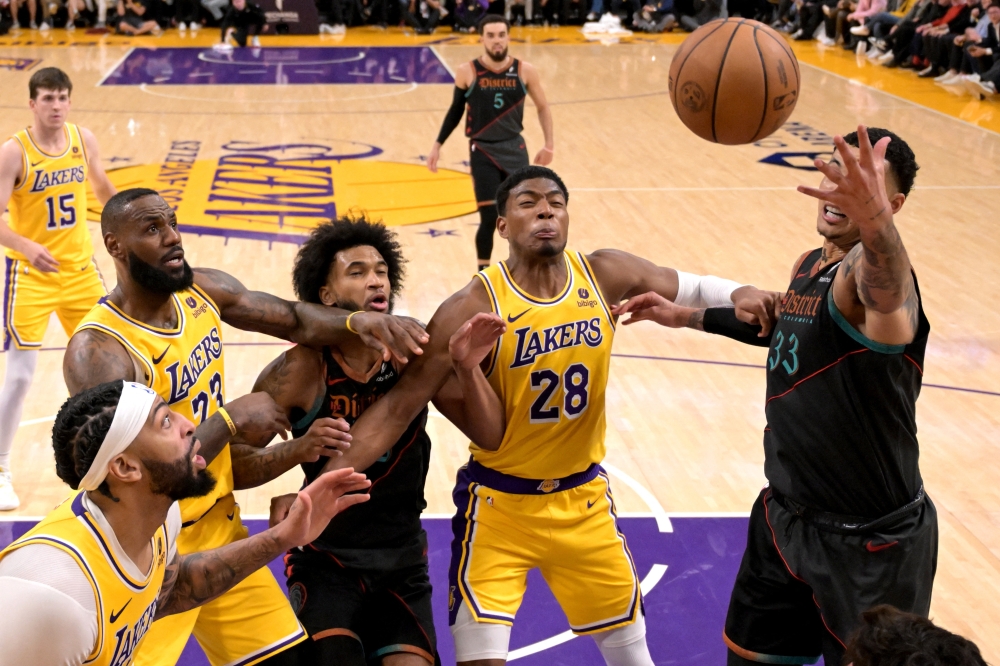 LeBron James (23), Marvin Bagley III (35), Rui Hachimura (28) and Kyle Kuzma (33) battle for a rebound