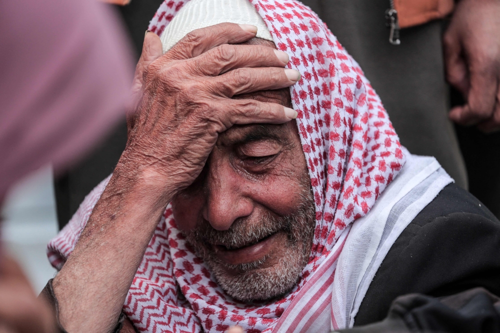 A Palestinian man mourns a relative killed during overnight Israeli bombardment 