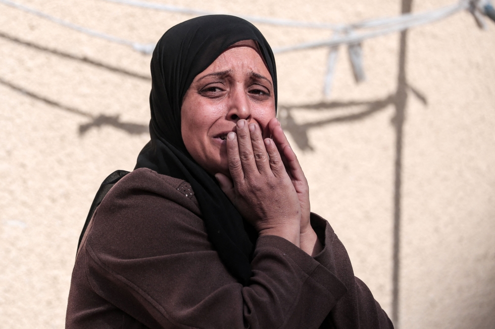 A Palestinian woman mourns a relative killed during overnight Israeli bombardment on Deir al-Balah 