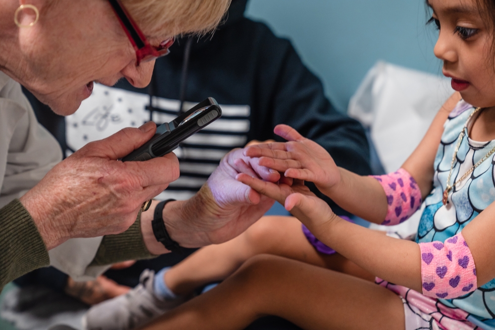 Dr. Jane C. Burns, director of the Kawasaki Disease Research Center at the University of California, San Diego, examines Inez Maldonado Diega 