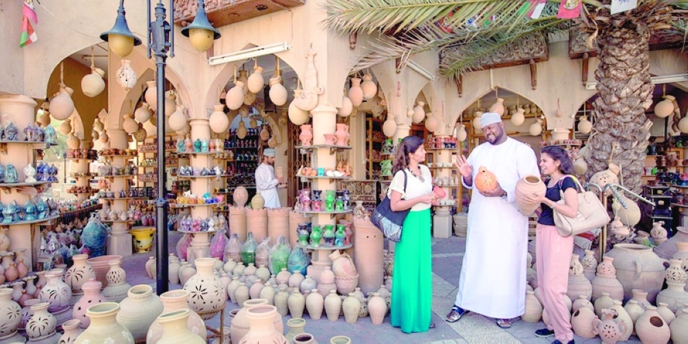 Tourists visit a pottery and handicrafts shop at a market in Nizwa, Oman.