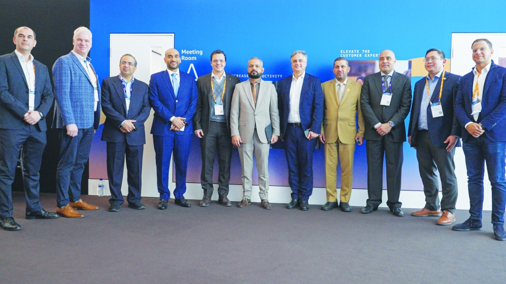 Omantel and Amazon Web Services representatives pose for a photo after the signing agreement.