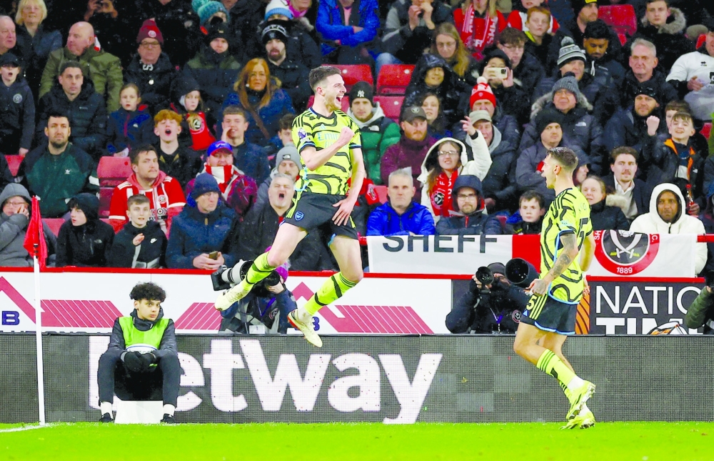 Arsenal's Declan Rice celebrates scoring their fifth goal with Jakub Kiwior. — REUTERS