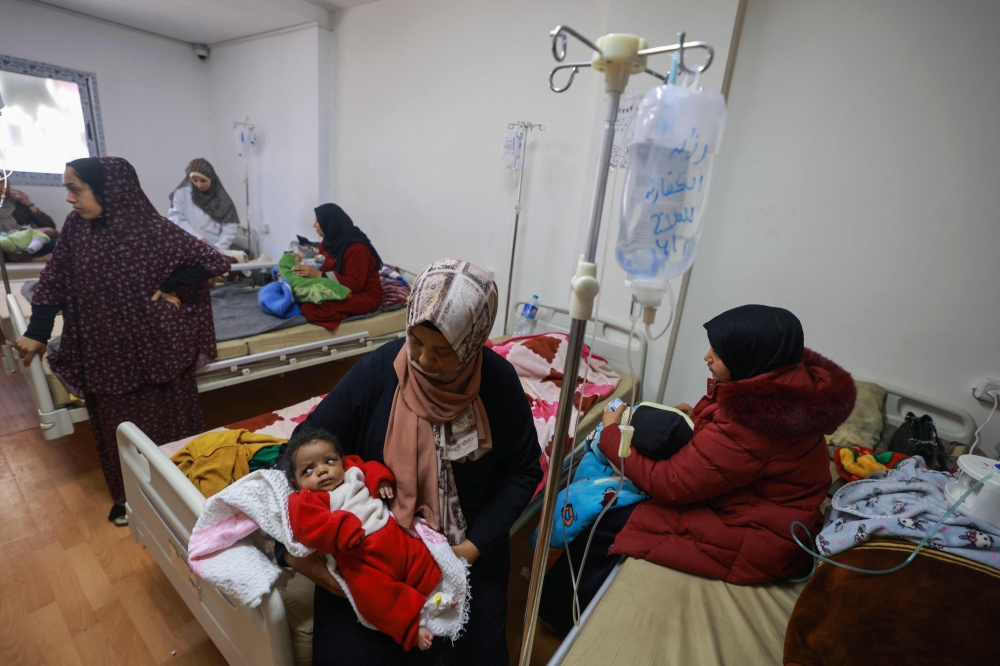 Palestinian children suffering from malnutrition receive treatment at a healthcare center in Rafah. — AFP