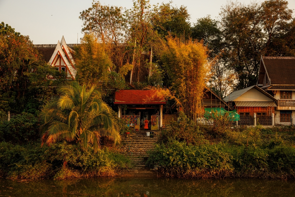 A monk is seen at a temple next to the Wang River in Lampang, Thailand, Feb. 23, 2024. (Andre Malerba/The New York Times)