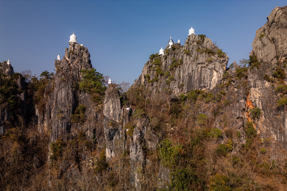 The temple in the sky, Wat Phra Phutthabat Sutthawat, has unadorned wooden shrines perched on the rocks in Lampang, Thailand, Feb. 25, 2024. (Andre Malerba/The New York Times)