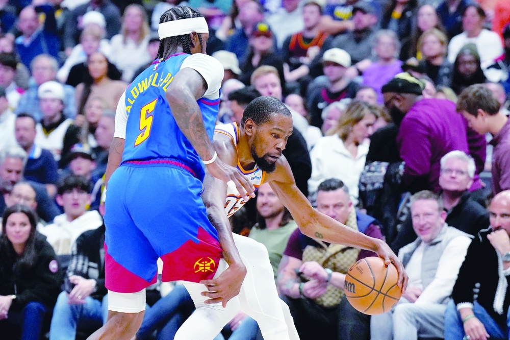  Phoenix Suns forward Kevin Durant (35) drives around Denver Nuggets guard Kentavious Caldwell-Pope (5) in the second half at Ball Arena. -- USA TODAY Sports