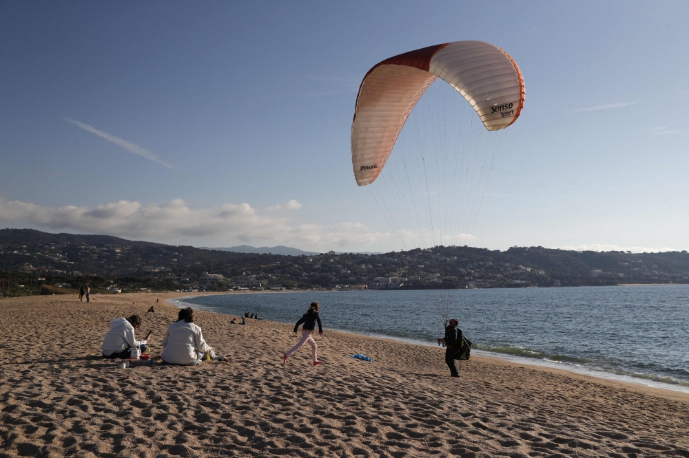 A man tests a paraglider along the beach during a warm weekend, on the French Mediterranean island of Corsica.  — AFP file photo