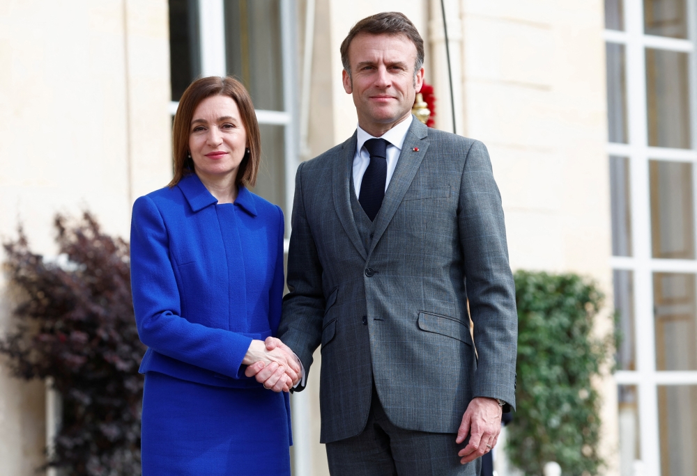 Moldova's President Maia Sandu shakes hands with French President Emmanuel Macron before a meeting at the Elysee Palace in Paris on Thursday. — Reuters