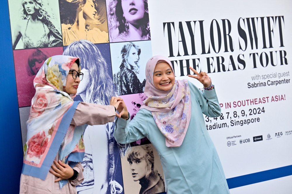 Taylor Swift's fans, or Swifties, pose for a picture at the National Stadium during Swift's Eras Tour concert in Singapore