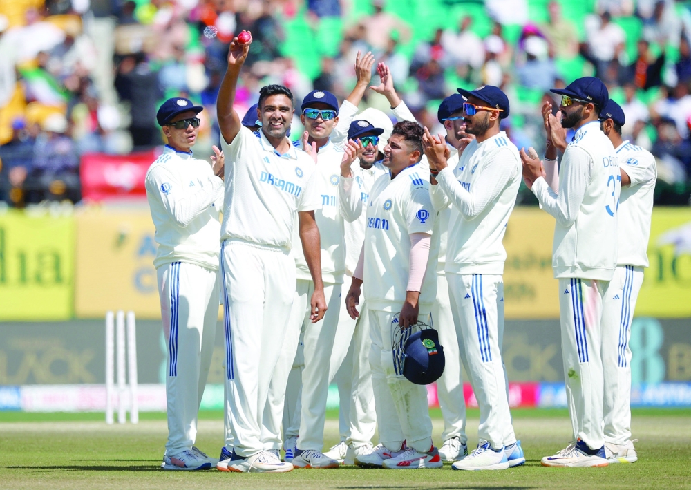 India's Ravichandran Ashwin acknowledges the fans and celebrates his five-wicket-haul with teammates. — REUTERS