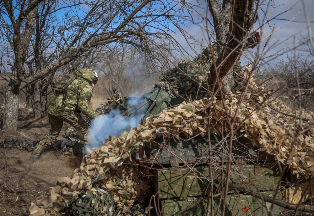 Ukrainian service members fire a 120-mm towed 2B16 "Nona-K" artillery-piece mortar towards Russian troops, near the town of Bakhmut in Donetsk region, Ukraine March 8. — Reuters 