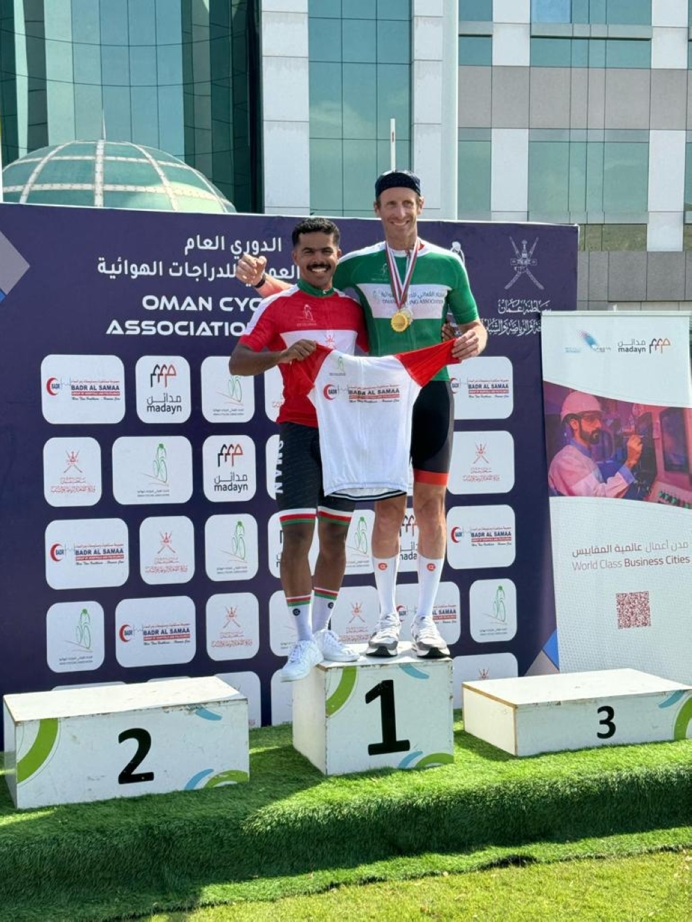 Cycle KOM's overall winner Mohammed al Wahibi and captain Paul Willcox pose with their jersies