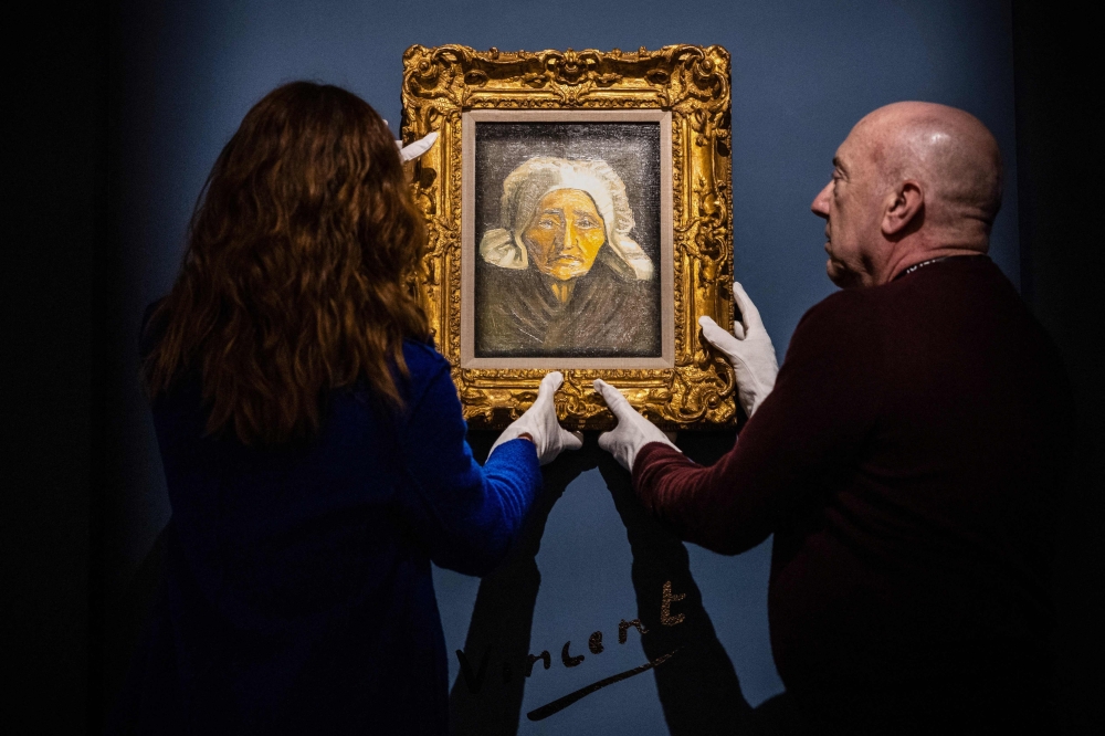 Staff members of Tefaf gallery, hung the rare Vincent van Gogh painting "Tete de paysanne a la coiffe blanche" (Head of an old farmer's wife with a white hat), probably painted in 1884, as it will be for sale from March 9 to 14, 2024, at Europe's largest annual art and antiques fair Tefaf in Maastricht, on March 6, 2024. The painting is offered by the American gallery M.S. Rau from New Orleans, which did not disclose an asking price.

 - Netherlands OUT
 (Photo by ROB ENGELAAR / ANP / AFP)

