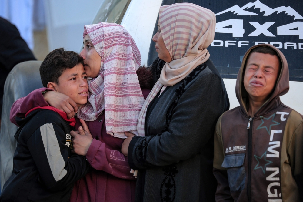 Palestinians mourn the death of a family member in the courtyard of the Al Aqsa Martyrs Hospital in Deir al Balah in the central Gaza Strip. - AFP
