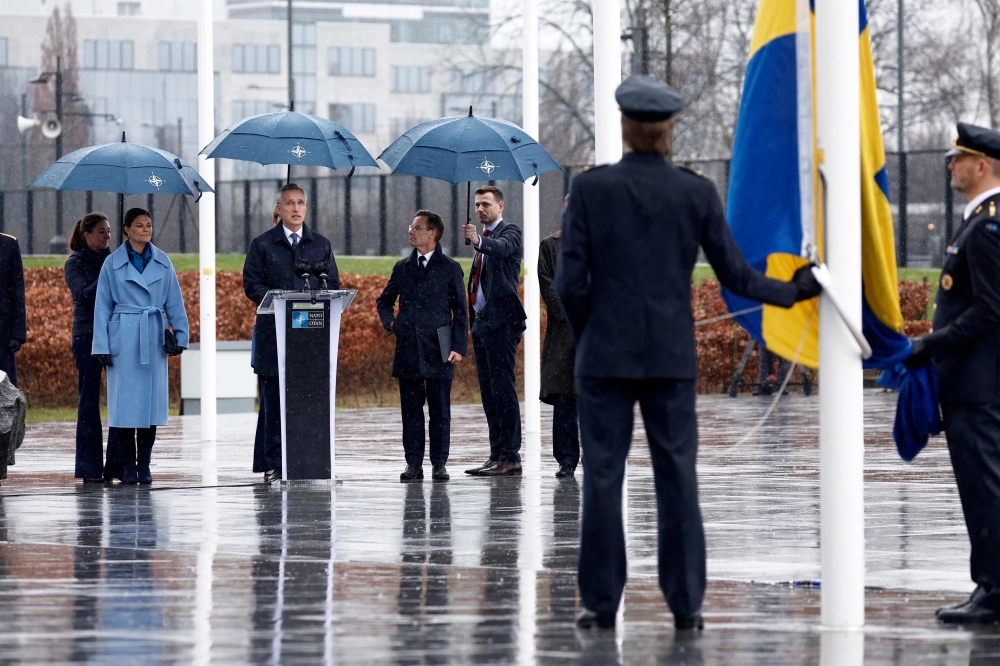 Nato Secretary General Jens Stoltenberg (C) gives a speech next to Crown Princess Victoria of Sweden and Swedish Prime Minister Ulf Kristersson during a flag raising ceremony for Sweden's accession to Nato at the North Atlantic Alliance headquarters in Brussels. — AFP 